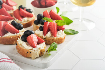 American flag sandwich with strawberries, blueberries, whipped sweet cream, soft cheese on toast bread. 4th of July American Independence Day food. Independence or Patriotic Day breakfast idea Mock up