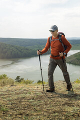 man hiking and enjoying the view summer nature. Enjoying nature, having a good time.