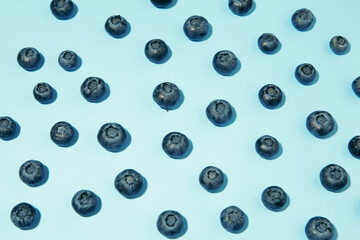 Colorful blueberries on blue background. Top view. Flat lay