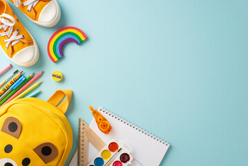 Early education essentials. Top-down view of a lively kid's school bag filled with colorful school...