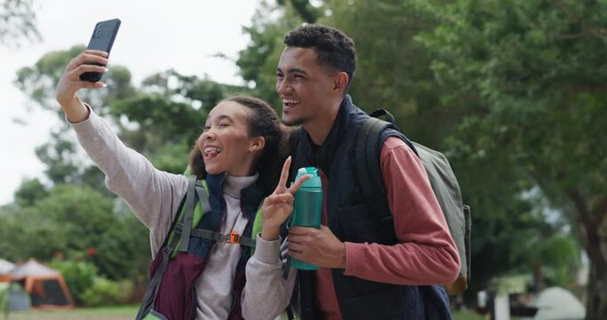 Happy couple, selfie and woods in camping with peace, smile and tongue for funny face on adventure. Man, woman and photography for social network, comic post and profile picture for hiking in forrest