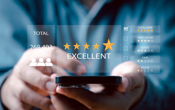 Businessman using smartphone to give golden five stars for client the best satisfaction evaluation survey after use product and service concept.