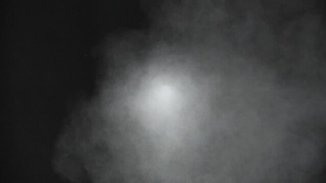 Close up scene of smoke spout out of hole, hot vapor rise up on boil water, exhaust pipe toxic fume, white spray color isolated on black background, steam of perfume fog in front view
