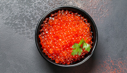 delicious red caviar in black bowl, top view, dark background - obrazy, fototapety, plakaty