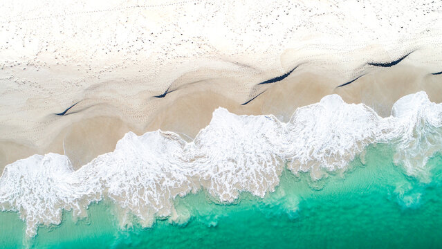An aerial shot of the aftermath of a crashing wave