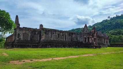 Fototapeta na wymiar The beautiful of sanctuary and the green natural walkway side of of Wat Phouvat Phou Hindu vat Phou Temple complex is the UNESCO world heritage site in Champasak, Laos at the blue cloud sky day.