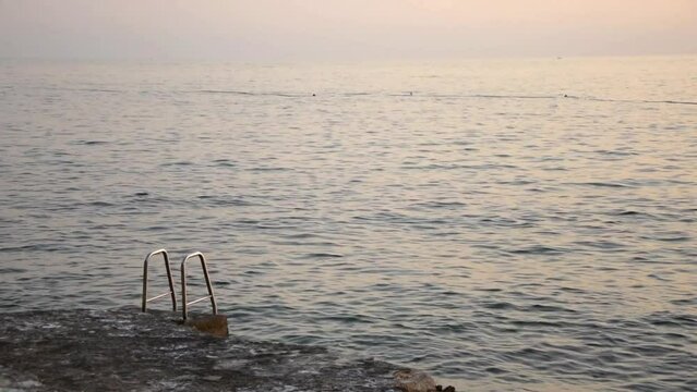 Evening seascape. Calm Adratic sea after sunset in Porec, Croatia
