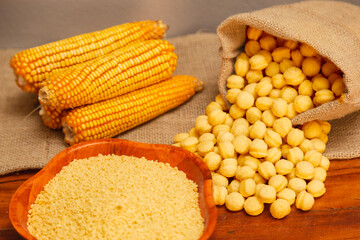 Corn cobs, corn flakes and corn snacks, bagged on a wooden background, generated with an extruder machine