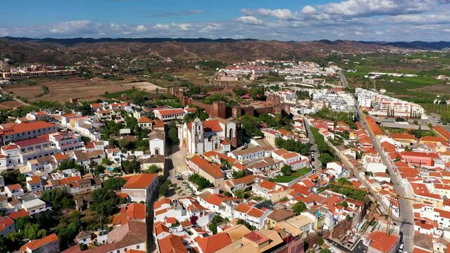 View of Silves town buildings with famous castle and cathedral, Algarve region, Portugal. Walls of medieval castle in Silves town, Algarve region, Portugal.