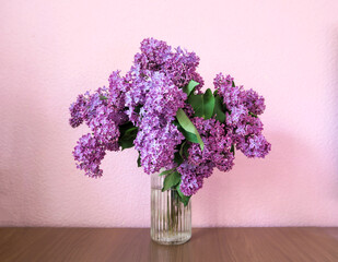 Bouquet of lilac on the desktop, on a white background  