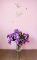 Bouquet of lilac on the desktop, on a white background  