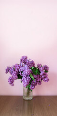 Bouquet of lilac on the desktop, on a white background  