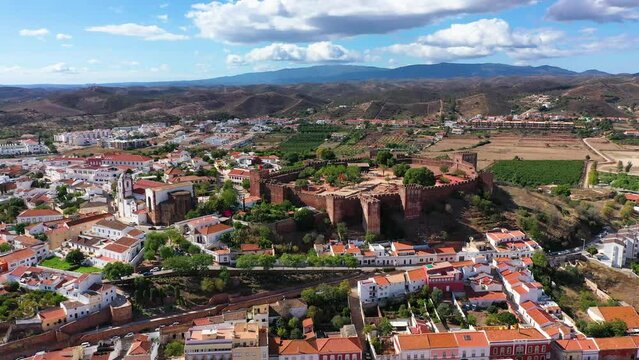 View of Silves town buildings with famous castle and cathedral, Algarve region, Portugal. Walls of medieval castle in Silves town, Algarve region, Portugal.