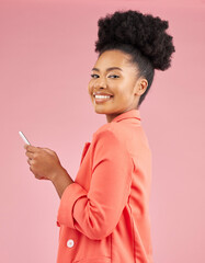 African woman, studio portrait and phone with texting, web chat or contact with smile by pink...