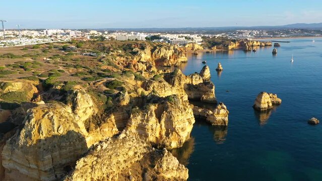 Camilo beach (Praia do Camilo) in Lagos, Algarve, Portugal. Wooden footbridge to the beach Praia do Camilo, Portugal. Picturesque view of Praia do Camilo beach in Lagos, Algarve region, Portugal.