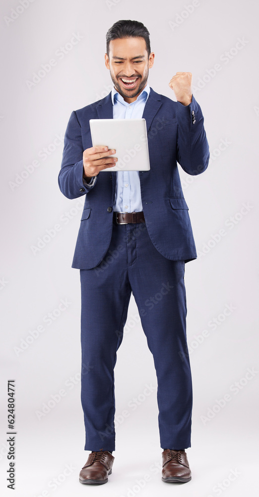 Poster Happy businessman, tablet and fist pump for winning, promotion or bonus against a grey studio background. Excited asian man in celebration on technology for good news, lottery prize or sale discount