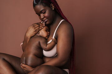 African beautiful mother huddling to her newborn baby