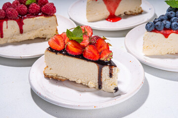 

Summer cafe baking menu background, sweet cheesecake portion slices with various toppings, jam and berry fruits - strawberry, blueberry, raspberry, cherry 