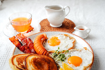 breakfast pancakes fried eggs and sausages