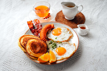 breakfast pancakes fried eggs and sausages