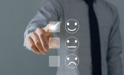 Man touching the virtual screen on the happy Smiley face icon to give satisfaction in service. Customer service evaluation concept..