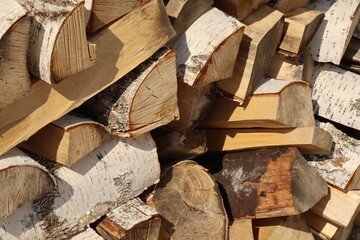 Brown birch firewood with a structure for a fireplace stove, a bath fire, a sauna on a clear day