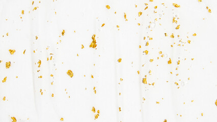 Transparent serum, serum, gel with 24 carat cosmetic gold smeared over the entire background.
