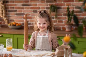 I m front of the camera cute and pretty girl blowing the flour while preparing a delicious dessert...