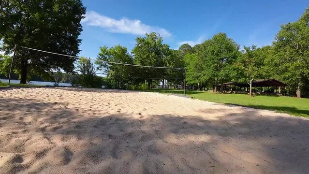 aerial FPV footage of a gorgeous summer landscape at Proctor Landing park with a lake, lush green trees, grass and plants with blue sky and clouds at Lake Acworth in Acworth Georgia USA