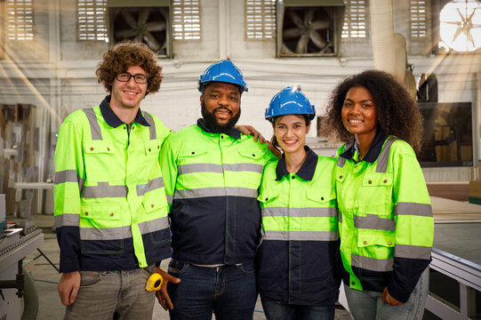 Team of professional carpentry engineers Smart multiethnic men and women. standing in a furniture factory