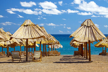 Summer beach with chairs and umbrellas in Montenegro