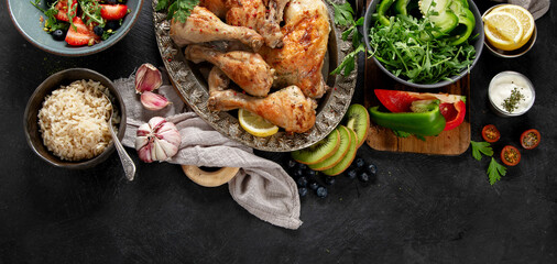 Fototapeta na wymiar Roasted chicken legs with fresh salads.