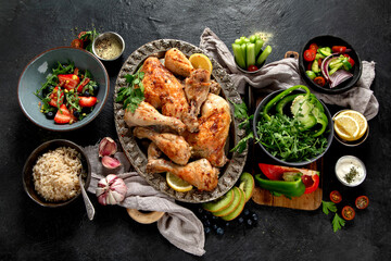 Roasted chicken legs with fresh salads.