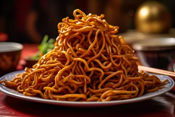 Fotobehang Shanghai Fried Noodles piled high on a plate, showing the glossy texture of the noodles © bartjan