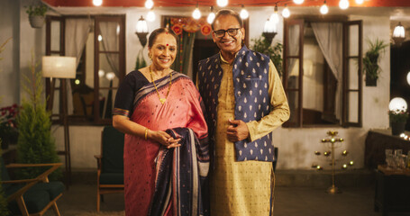 Portrait of Happy Indian Elderly Couple in Traditional Clothes Posing Together at Their Authentic Mumbai Home. Senior Husband and Wife Celebrating Diwali, Looking at the Camera - obrazy, fototapety, plakaty