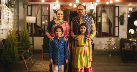 Portrait of Indian Family in Traditional Clothes Posing Together in Authentic Mumbai House. Senior Grandparents and Their Cute Grandkids Looking at the Camera, Happily Taking a Family Photo