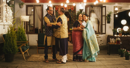 Authentic Shot of Indian Elderly Couple Receiving Family Relatives Over. Genuine Happiness in a...