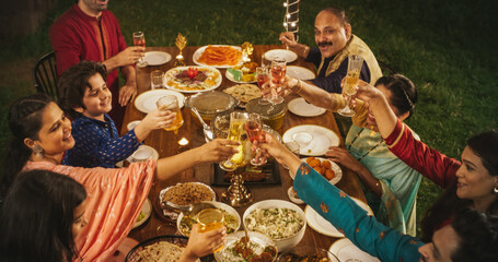 Happy Indian Family Having a Feast and Celebrating Holiday Together: Group of People of Different...