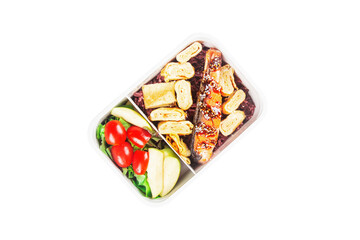 Lunch box with grilled salmon topped with white sesame seeds and egg rolls with apple and tomato green oak salad.