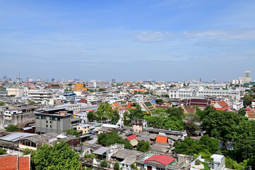 Obraz premium BANGKOK, THAILAND - July 22, 2023 : Landscape View of Bangkok City and Thai Buddhist Temple with Blue sky with white cloud. Clear day and good weather in the morning.
