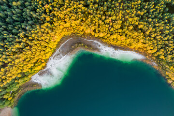Aerial view of beautiful green waters of lake Gela. Birds eye view of scenic emerald lake surrounded by pine forests. Clouds reflecting in Gela lake, near Vilnius, Lithuania.