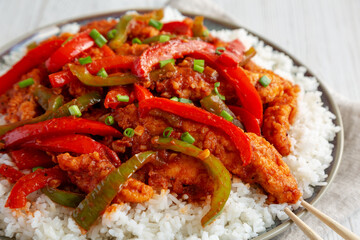 Homemade Simple Chili Chicken with White Rice on a Plate, side view. Close-up.