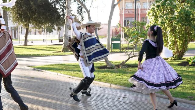 young latin american couple dancing cueca folklore dressed as huaso
