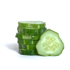 Cut cucumber slices are stacked on top of each other on a white background