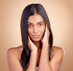 Portrait, hair care and Indian woman with beauty, makeup and dermatology on a brown studio...
