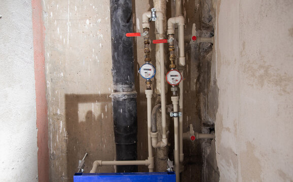 Water meters and polypropylene pipes for cold and hot water. Bypass and taps for heated towel rail. Copy space for text