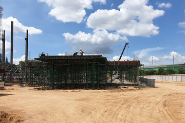 Construction work of the structure building by workers in the factory industrial.