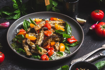 Warm eggplant, pepper, tomato and basil salad