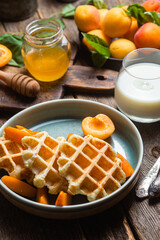 Cottage cheese wafers with apricots and honey in a bowl