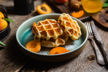 Cottage cheese wafers with apricots and honey in a bowl